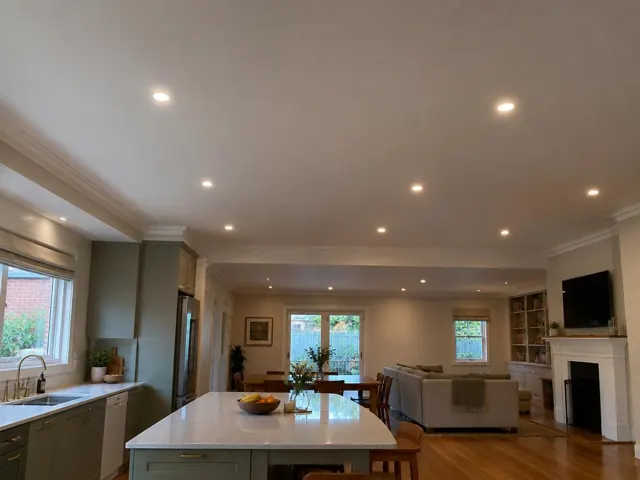 Ceiling downlights in open-plan kitchen and living room with timber floors in Freshwater